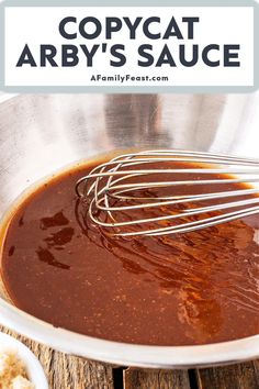 the sauce is being whisked in a metal bowl