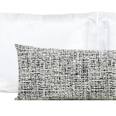 two pillows with black and white designs on them, one has a pillow case in the shape of a rectangle