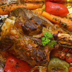 a close up of food on a plate with carrots and peppers