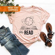 Read Shirt, Reading Shirt, Reading T-Shirt, Reading Week Teacher Shirt, Librarian Shirt, Book Lover Shirt, Book T shirt, Teacher Shirts  BLACK TEXT is used for Yellow, Heather Peach, White, Light Gray Heather, Mint, Pink Shirts. Other colored shirts have white text. F I T ∙ & ∙ S I Z I N G : -->Women's sizes are narrower than the waist. -->Sleeves are rolled up in some product pictures. They do not come rolled up on delivery. T I M E ∙ T O ∙ D E L I V E R Y : -->Processing and production time is Reading Week, Pink Shirts, Librarian Shirt, Text Shirt, Reading Shirts, Book Tshirts, Shirts Black, Product Pictures, Pink Shirt