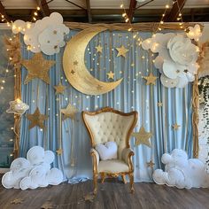 a room decorated with balloons, stars and moon decorations