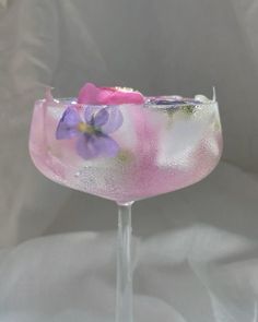 a wine glass with flowers painted on it