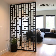 a living room with a black couch and white walls