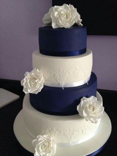 three tiered wedding cake with white flowers on top