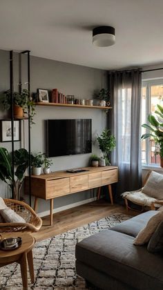 a living room filled with furniture and a flat screen tv on top of a wooden shelf