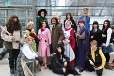 a group of people dressed in costumes posing for a photo