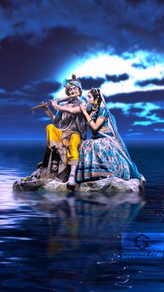 two people sitting on top of a rock in the middle of the ocean under a cloudy sky