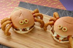 two hamburgers with googly eyes and onion rings