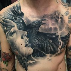 a man with tattoos on his chest is holding a crow