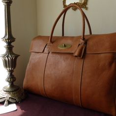 Perfect Travel Or Work Bag Expandable, Soft, Light Brown, Leather. Some Scratches And Marks From Use. Sturdy And In Great Condition. This Bag Gets Compliments All The Time! Elegant Cognac Satchel Travel Bag, Elegant Cognac Bag With Luggage Sleeve, Classic Brown Travel Bag With Dust Bag, Travel Briefcase With Dust Bag In Brown, Luxury Light Brown Shoulder Bag For Travel, Elegant Light Brown Travel Bag, Classic Light Brown Satchel For Travel, Luxury Light Brown Satchel For Travel, Luxury Light Brown Travel Satchel