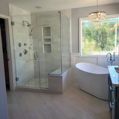 a bathroom with a tub, shower and sink