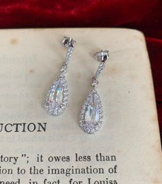 We love the inspiration from the past and these very sparkly and extremely glamorous 1920's style teardrop silver and cubic zirconia earrings look like they have just come off The Great Gatsby film set. The perfect finishing touch to your special outfit. Rhodium plated to prevent tarnishing. Sterling silver Hand made Highest quality AAA* cubic zirconia Rhodium plated to prevent tarnishing Great Gatsby Film, 1920's Style, The Great, Sterling Silver Drop Earrings, The Great Gatsby, Cubic Zirconia Earrings, Film Set, Zirconia Earrings, Great Gatsby