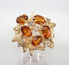 a gold ring with citrine and white diamonds on the top, set in 18k yellow gold