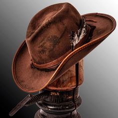 Description -Felt Wool Material -Brim 3 1/2" -Crown 4 3/4" -Cowhide Leather Hat Band -Leather Accents -Hand Distressed Finish The Duke Brown is the hat I'd choose if I were to fight a grizzly bear. This felt cowboy hat is hand distressed to give it a rugged textured look that you just can't find with other competitors. This hat looks and feels like a valuable heirloom while having the quality to last as long as any family heirloom. With a rugged pioneer look like this even Davy Crockett would en Rustic Short Brim Felt Hat For Ranch, Brown Western Top Hat For Outdoor, Rustic Ranch Hat With Short Brim, Rustic Brown Felt Hat For Outdoors, Western Style Short Brim Top Hat For Outdoor, Rustic Brown Felt Hat For Outdoor, Western Style Top Hat With Short Brim, Western Style Short Brim Top Hat, Rustic Felt Hat With Flat Brim For Outdoor