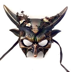 Step into the mystical embrace of the forest with our captivating masquerade mask. The horned elements add an air of mystery and majesty, creating a unique and captivating look. From masquerade balls to extravaganzas and special celebrations, our forest mask will catch attention!


Age Group/Gender - Adult/Mens

Size/Type - One size fits all adults

Mask Color - Forest green/gold accents

Mask Material - Polyresin

Accent Material - Paint

Special Features - Foliage Gothic Horned Masks For Fantasy Events, Gothic Horned Masquerade Mask For Costume Party, Gothic Masks And Prosthetics For Carnival Fantasy Events, Gothic Masks And Prosthetics For Carnival, Fantasy Horned Masquerade Mask For Costume, Fantasy Masks For Carnival And Festivals, Fantasy Carnival Mask For Festivals, Gothic Eye Mask For Fantasy Events, Horned Fantasy Masquerade Mask For Halloween