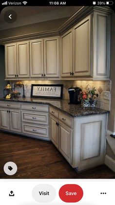 a kitchen with white cabinets and granite counter tops