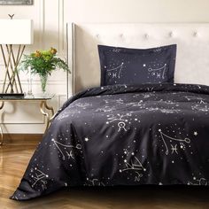 the comforter is black and has white stars on it, along with a pillow case