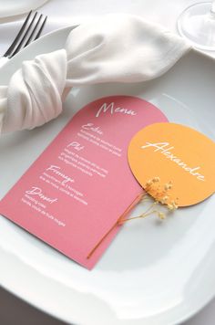 a table setting with place cards and napkins