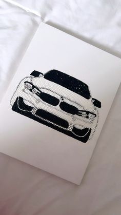 a white car with sunglasses on it's face is shown in black and white