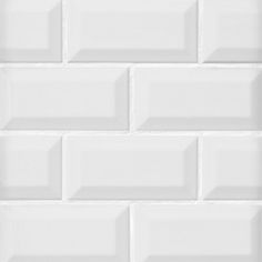 a white brick wall that is very close to the ground