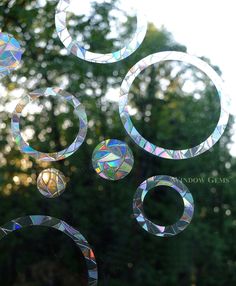 the sun shines through some bubbles in front of trees