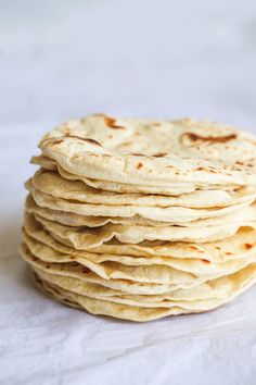 a stack of tortillas sitting on top of a white table