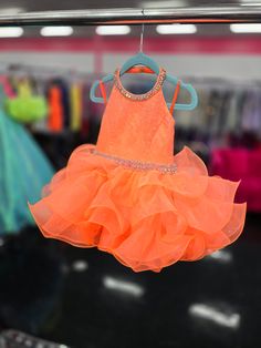 Sugar Kayne C220 Girls Baby Halter Cupcake Ruffle Pageant Dress Corset Formal GownHave your little cupcake bring on all the charm in this stunning organza gown. The corset back is the perfect addition as the little one grows!Colors: Neon OrangeSizes: 2TFabric Organza, Satin Lining Sleeveless Ruffled Pageant Dress, Orange Ruffled Dress For Dress-up Occasions, Orange Ruffled Dress For Dress-up, Cupcake Pageant Dress, Organza Gown, Organza Gowns, Dress Corset, Corset Back, Pageant Dress