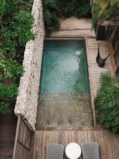 an aerial view of a small pool with two chairs