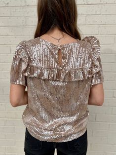 Life's a party and you'll be center stage in this sassy sequin top! Whether you choose vibrant pink or subtle taupe, you'll be ready to dance the night away with its short sleeves and flirty ruffle detail. Get the life of the party look in this fun top! 95% Polyester 5R% Elastane