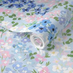 a floral wallpaper with blue, pink and green flowers on a light blue background