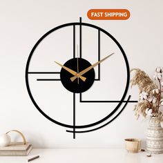 a clock that is on the wall next to a vase with some flowers in it