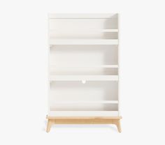 a white bookcase with three shelves on one side and two drawers on the other