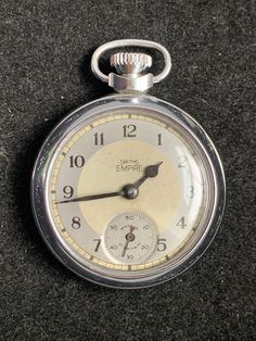 Smiths Empire Mens Grey/silver Dial Open Face (Bullseye) Chrome Plate Pocket Watch Chrome Plated Smiths Empire Men's Open-Faced Pocket Watch from the C1953.  Crown wind and adjust Arabic Numerals, subsidiary second-hand dial. In working condition.  Made in Great Britain. this one has the two-tone grey/silver dial which has been left uncleaned so it shows the age movement signed L3 which i believe is for 1953 (as from the 60s they used the year ie 63 ect)  Dimensions approx :  Diameter 51mm (not Timeless Silver Watch Accessories With Stopwatch, Silver Chronograph Pocket Watch For Formal Occasions, Silver Timeless Pocket Watch With Stopwatch, Silver Watches With Stopwatch, Timeless Silver Pocket Watch With Stopwatch Feature, Classic Silver Pocket Watch With Stopwatch, Antique Silver Watch With Round Dial, Silver Pocket Watch With Subdials, Classic Silver Pocket Watch With Metal Dial