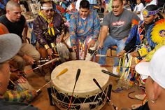 a group of men playing musical instruments in a crowd