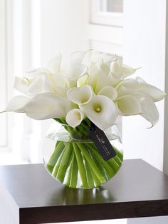 a vase filled with white flowers on top of a table