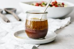 a spoon in a jar filled with food on a plate