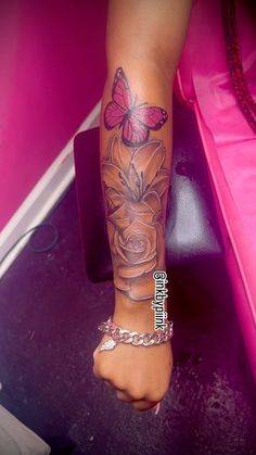 a woman's foot with a butterfly on it and flowers in the middle of her leg