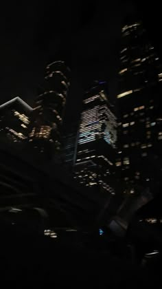 some very tall buildings at night time