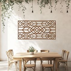 a dining room table with chairs and a plant hanging on the wall above it,