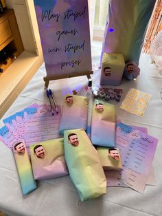 a table topped with lots of paper bags filled with pictures and writing on top of it