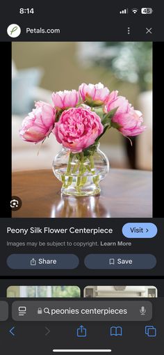 a vase with pink flowers in it sitting on a table next to an iphone app