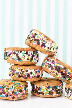 a stack of cookies with sprinkles and chocolate chips on them, stacked up