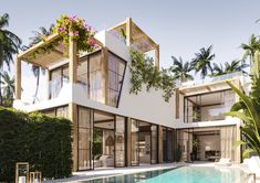 a house with a pool in front of it and some plants around the pool area