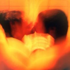 blurry image of two people kissing in the bathroom