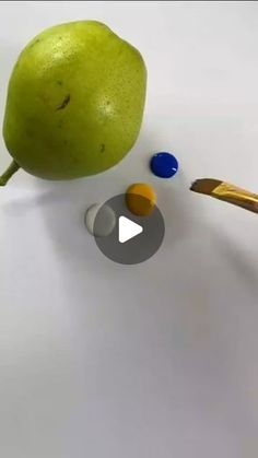 an image of a green pear being drawn with colored pencils