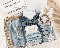 a gift box filled with blue and gold items