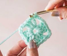 someone is crocheting a square with yarn