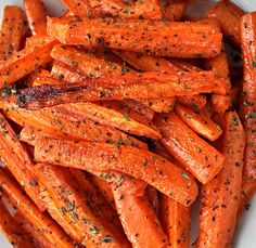 a white plate topped with carrots covered in seasoning