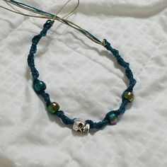 New! Handmade Skull Hemp Bracelet Teal String Natural Colored Hemp Purple/ Green / Teal Pony Beads Silver Skull Bead Closure: Hoop & Tie Handmade Casual Skull Bracelets, Handmade Casual Skull Bracelet, Casual Handmade Skull Bracelets, Casual Blue Jewelry For Festivals, Adjustable Handmade Skull Bracelets, Handmade Adjustable Skull Jewelry, Casual Skull Jewelry For Gifts, Casual Skull-shaped Jewelry For Gifts, Casual Skull-shaped Jewelry Gift