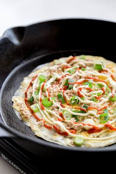 a black pan filled with food on top of a stove